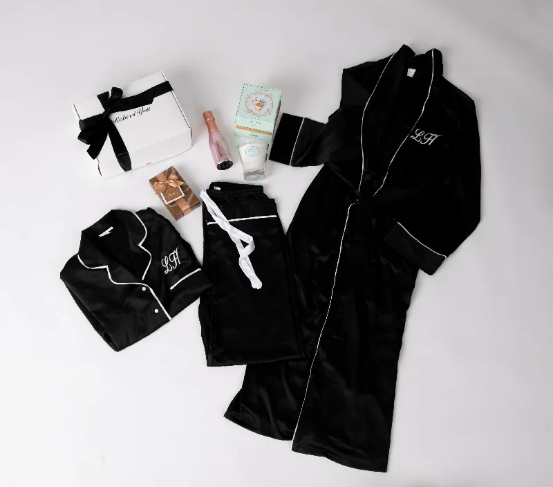 women's pajamas for those who value qualityLong Luxurious Silky feel full lenght black satin robe with piping with Matching Pyjamas with chocolates, champagne, candle all presented in a gift box